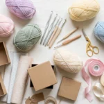 Illustrative flat lay of yarn, crochet hooks, gift boxes and ribbon on a light background — illustrative image, not a photo of any linked pattern.